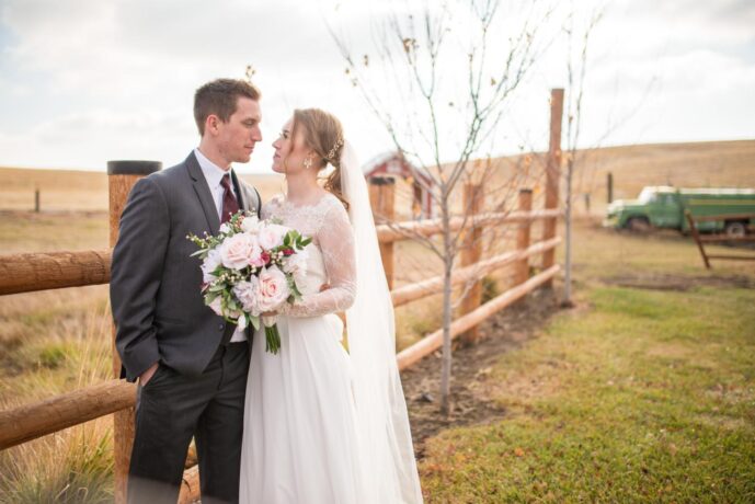 couple mid-shot by fence