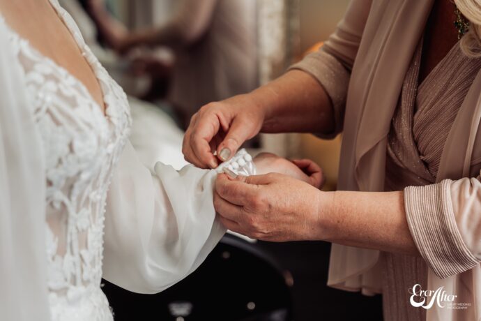 Bride getting her dress sewn