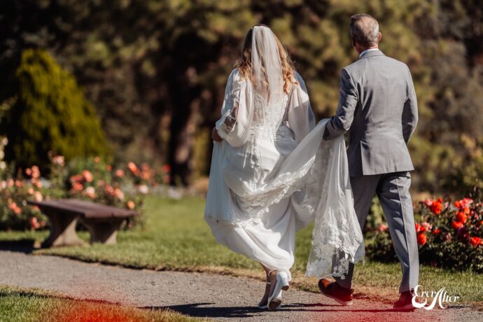 Dad walking bride down the isle, holding her dress