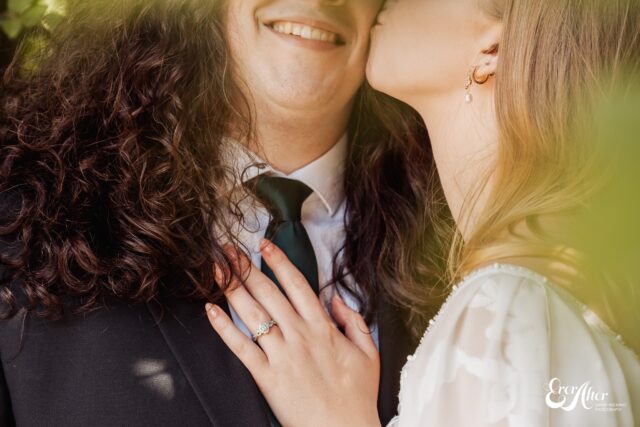 Close up of bride kissing a smiling grooms cheek