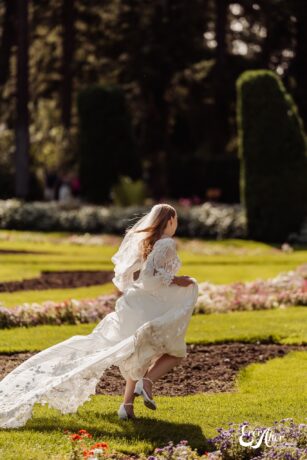 Bride running through a flower garden