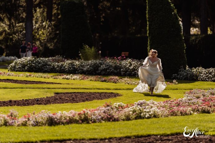 Bride running through a flower garden