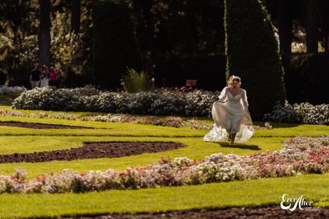 Bride running through a flower garden