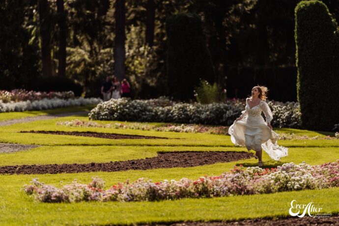 Bride running through a flower garden